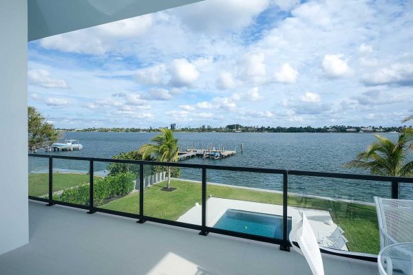 Scenic waterfront view from balcony overlooking pool.