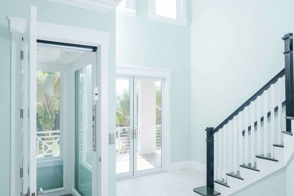 Modern home interior with elevator and staircase.
