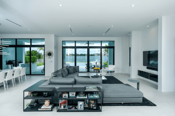 Modern living room with lake view and gray sofa.
