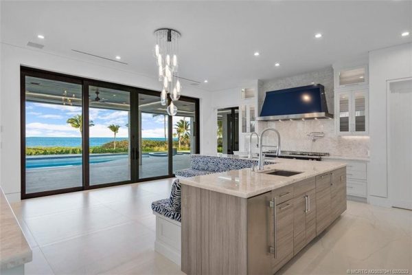 Modern kitchen with ocean view and island sink.