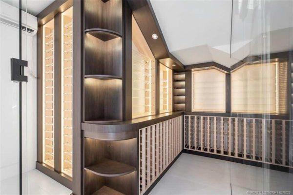 Modern wine cellar with wooden racks and shelves.