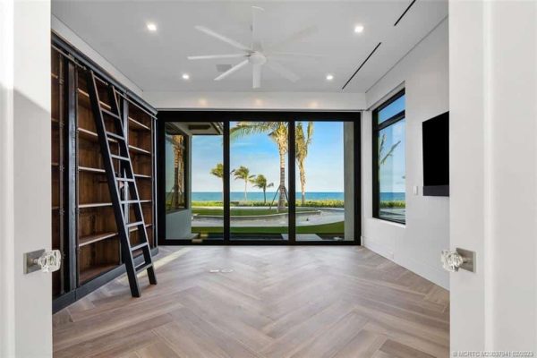 Modern room with ocean view and bookshelves