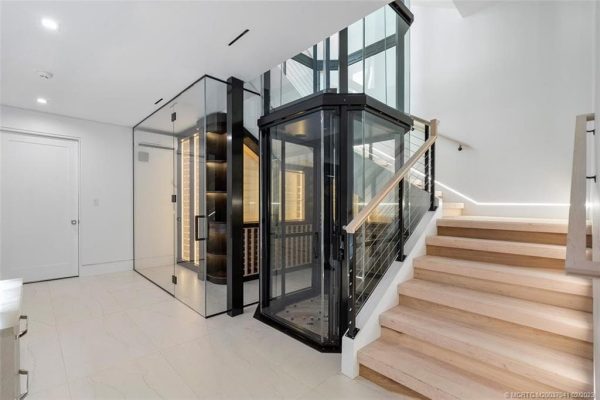 Modern home staircase with glass elevator
