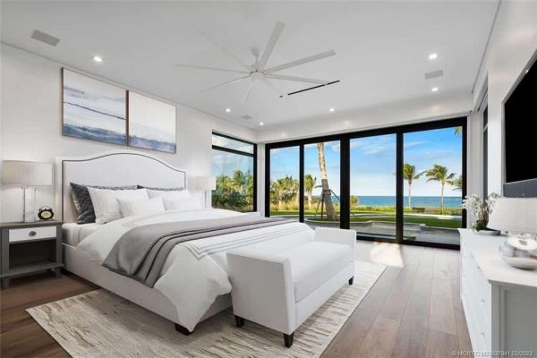 Luxury bedroom with ocean view and modern decor.