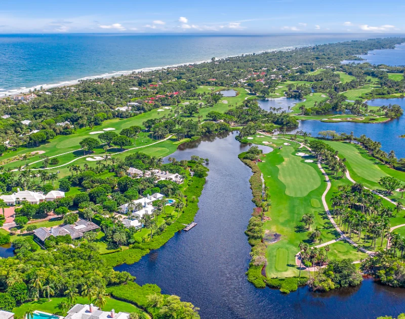 Aerial view of golf course by the ocean.