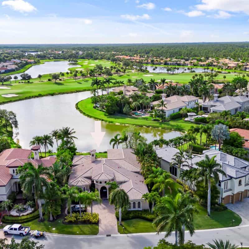 Aerial view of luxury homes by a golf course.