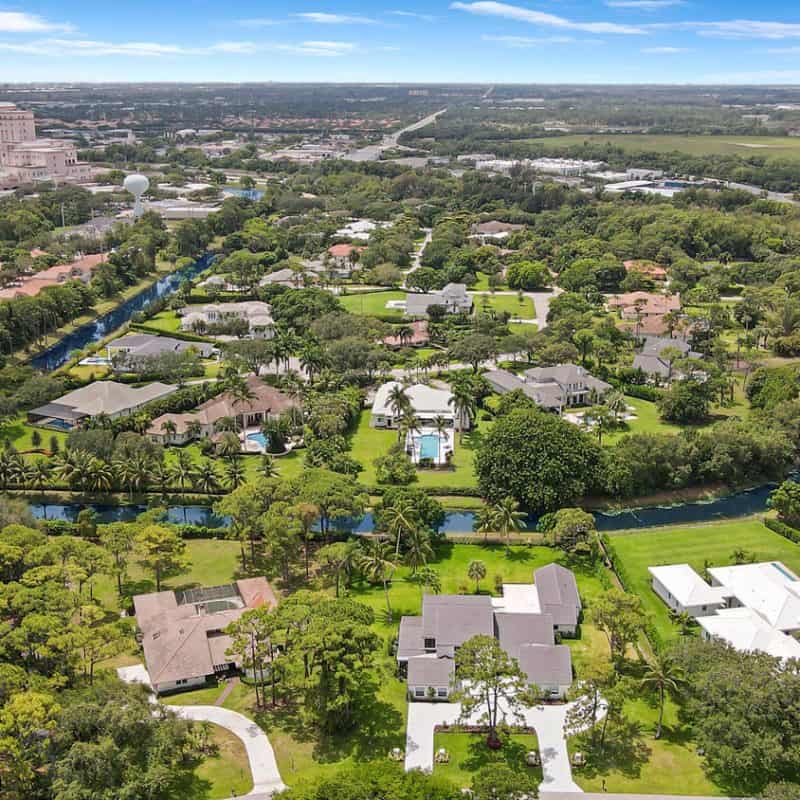 Aerial view of suburban homes and lush greenery.